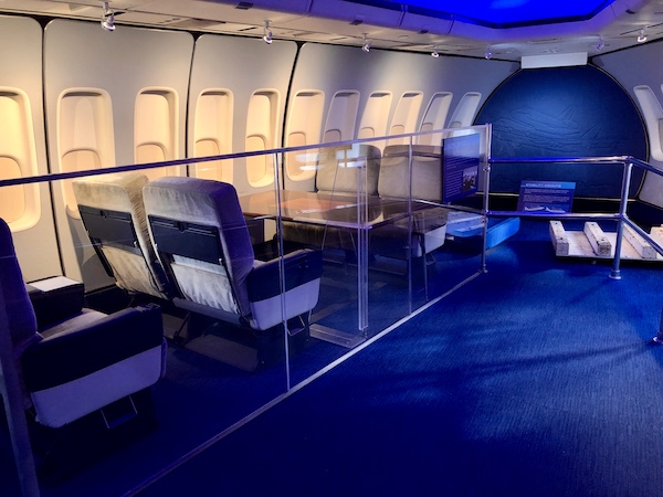 The interior of a plane with seats and table at the NASA Space Center Houston