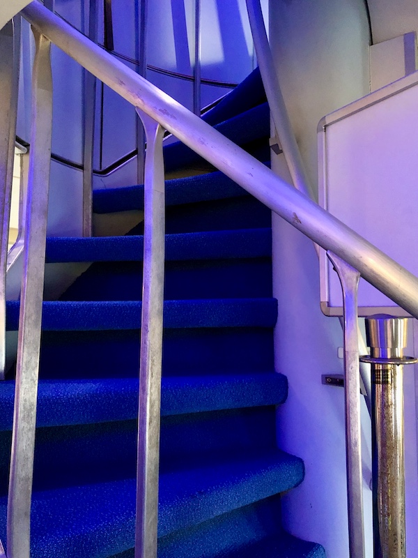 A spiral staircase lit in purple on a 747 at NASA Space Center Houston