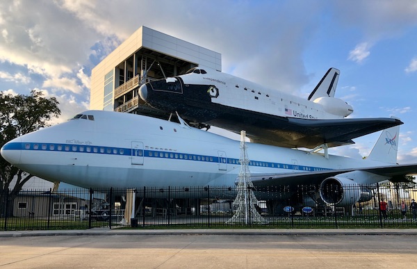 A 747 airplane with a space shuttle attached at the top for transport at NASA Space Center Houston