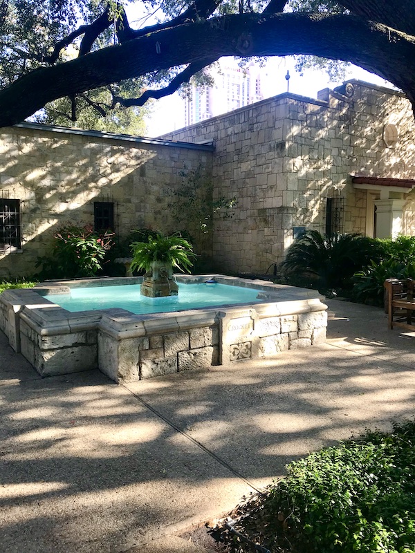 A large fountain on the grounds behind the Alamo