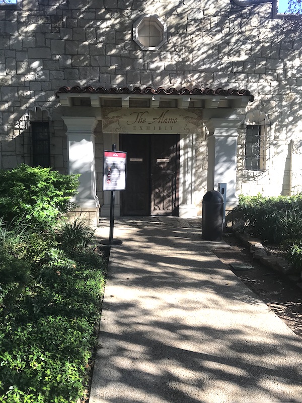 The entrance to a white building at the Alamo