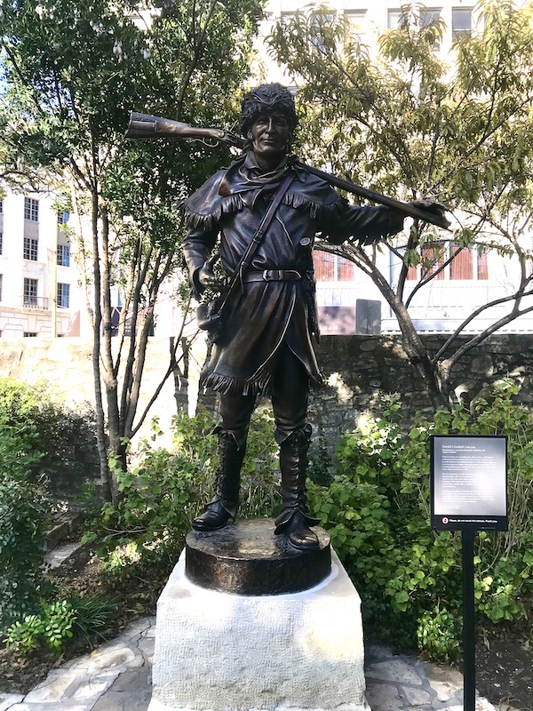 A bronze statue of David Crockett helps us Remember the Alamo