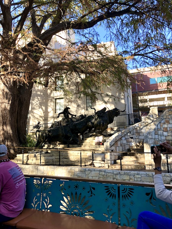 An art museum building with a western statue in front viewed along our San Antonio River Cruise
