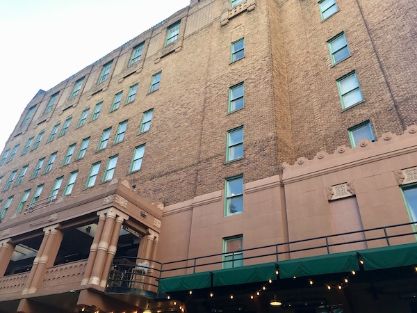 A tan brick apartment building along our San Antonio River Cruise