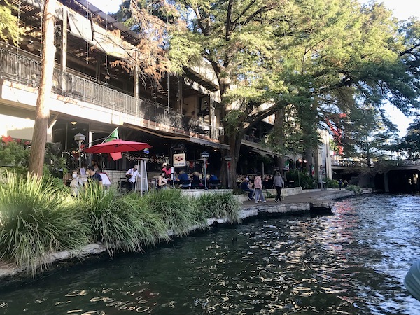 Outdoor dining at a restaurant along the route of our San Antonio River Cruise