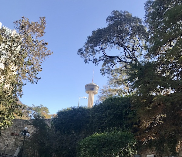 A tower peeks out from behind trees along our route on our San Antonio River Cruise