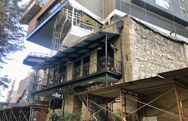 An old tavern building with scaffolding for renovations along our San Antonio River Cruise