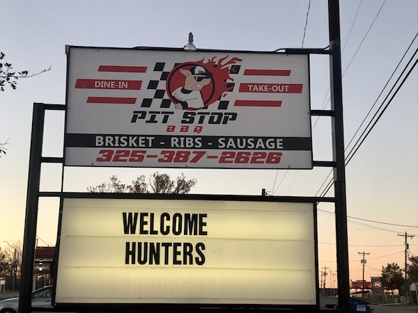 A sign tells you you are at the Pit Stop BBQ in Sonora Texas