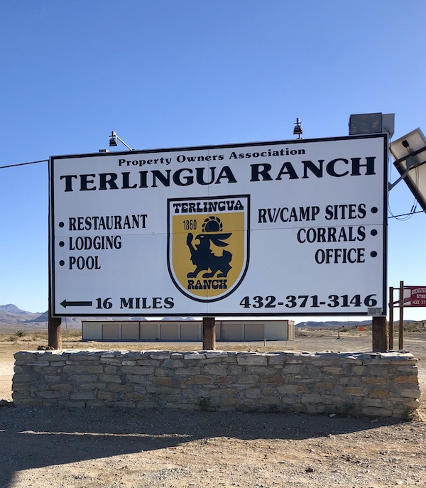 A large white road sign tells about Terlingua Ranch Texas