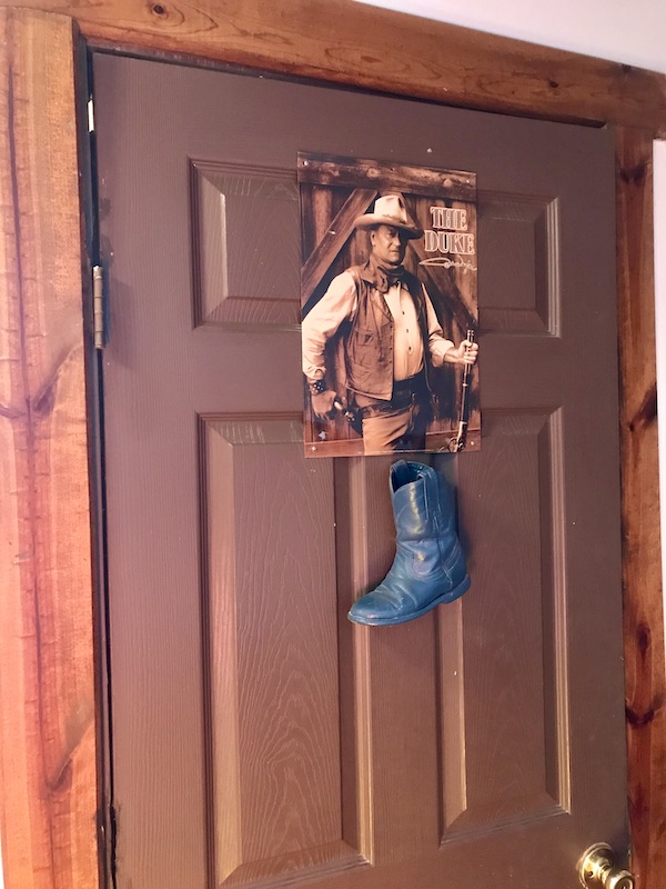 A cowboy on the door to the men's room at Terlingua Ranch Texas