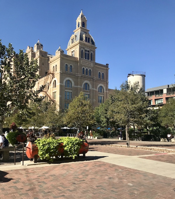 A large beige brick hotel/restaurant building in The Pearl in San Antonio