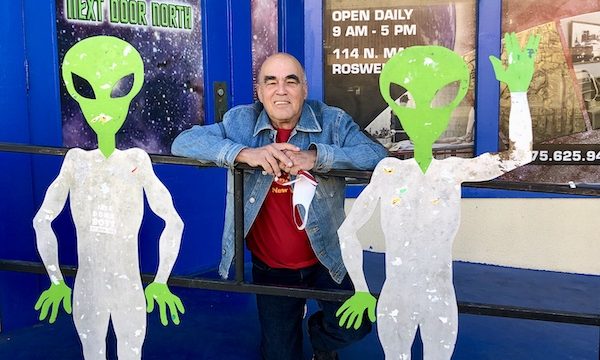 Two green men in white suits and a man in a jeans jacket prove that Aliens Abound in Roswell New Mexico