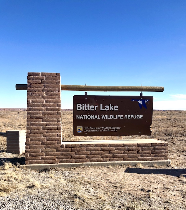 A brick column and sign for the Bitter Lake Wildlife Refuge where Aliens Abound in Roswell New Mexico