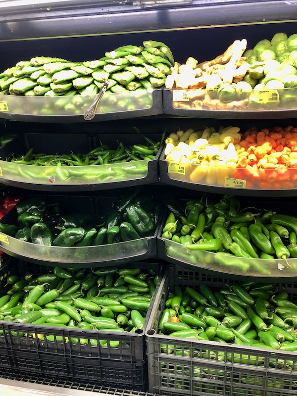 A produce display of peppers and cactus paddles where Aliens Abound in Roswell New Mexico