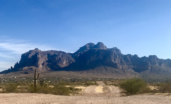 A dark rocky mountain with desert in the foreground at Apache Trail Arizona