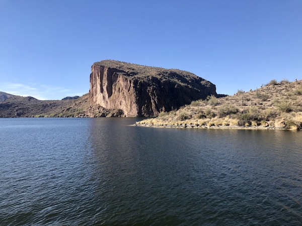 A large rock formation at the edge of a lake along the Apache Trail Arizona