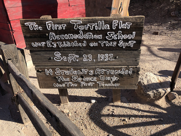 A brown sign with white writing about the first school along the Apache Trail Arizona