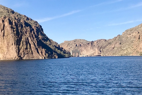Rock mountains with a dam and blue lake water along the Apache Trail Arizona