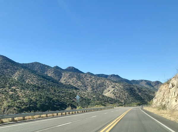 A highway with mountains lining the route from Bisbee Tombstone and Boot Hill in Arizona