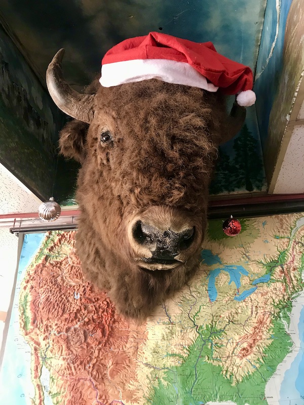 A buffalo head with a Santa hat hanging above a map at the O.K. Café in Tombstone AZ