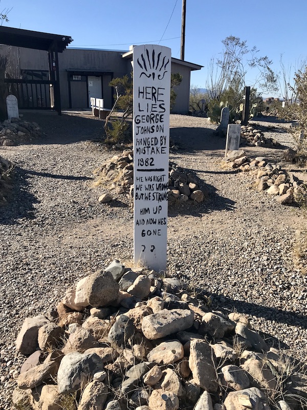A white wood grave marker at Boothill Graveyard