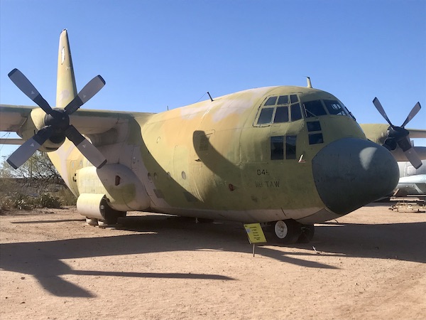 A very large cargo plane painted in camouflage at the Pima Air and Space Museum