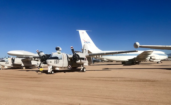 A dark gray plane and a white and blue plane at the Pima Air and Space Museum