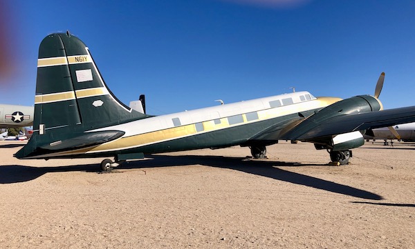 An olive green and bright metallic gold plane at the Pima Air and Space Museum