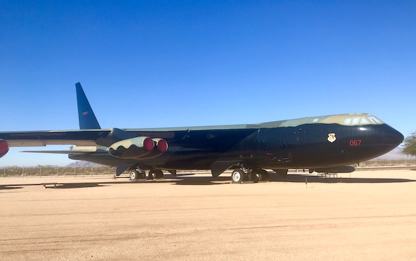A large bomber airplane painted dark olive at the Pima Air and Space Museum
