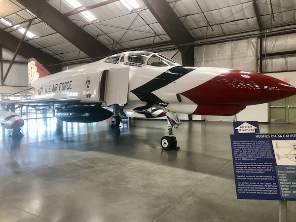 A white jet with red and blue stripes on the nose at the Pima Air and Space Museum