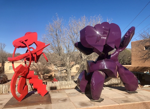 A red and a purple metal sculpture along our drive from Santa Fe to Albuquerque New Mexico