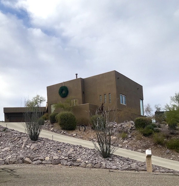 A boxy tan house with a steep driveway seen on our way back from the Sonoran Desert Museum