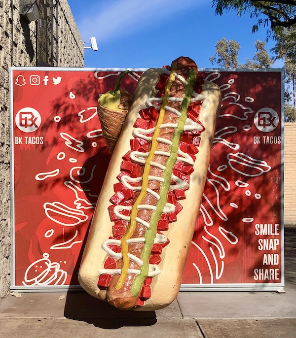 A red and white sign with a 3-D hotdog showing all the toppings on our way to Sonoran Desert Museum