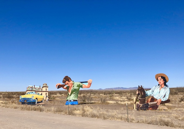 Huge cut outs of people, a yellow car and a ranch just past The Waterstop Marfa Texas