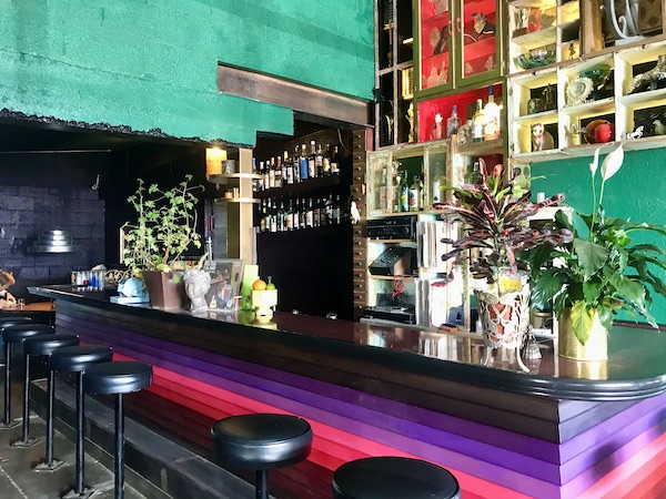 A restaurant bar with colorful art at The Waterstop Marfa Texas