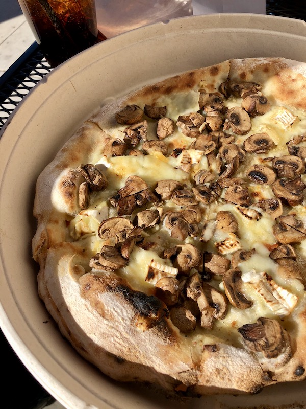 A pizza with mushrooms and Brie cheese in Beautiful Redlands California