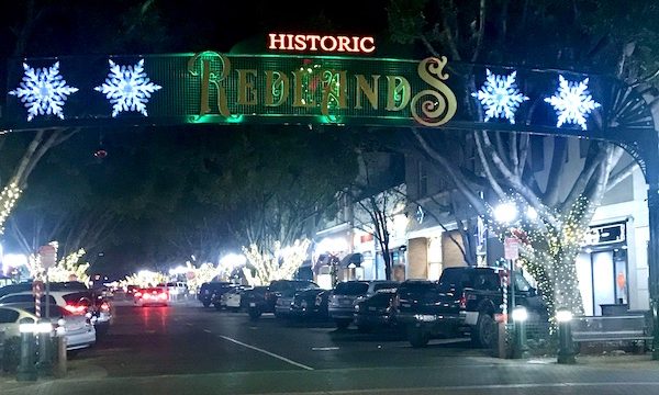 A banner running across a street that says Historic Redlands, downtown in Beautiful Redlands California