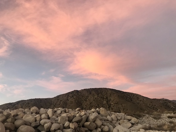 Deep pink clouds and blue sky with a mountain in the foreground in Beautiful Redlands California
