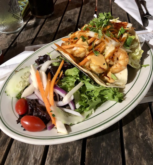 An oval white platter topped with vegetables and tacos at a dinner on our journey Coast to Coast We Did It!