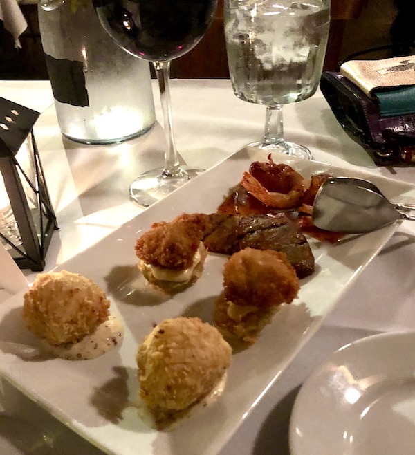 A large white oblong plate topped with hors d'oeuvre enjoyed en route Coast to Coast We Did It!