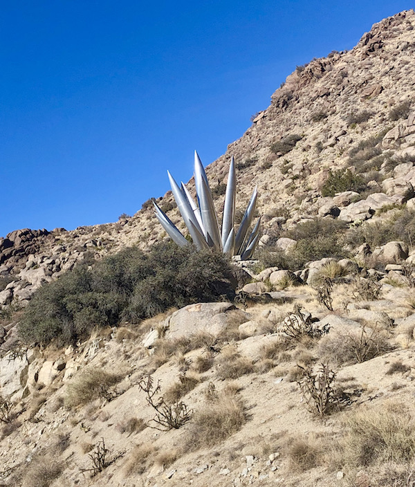 A metal sculpture of a plant with spikes on a mountainside en route Coast to Coast We Did It!