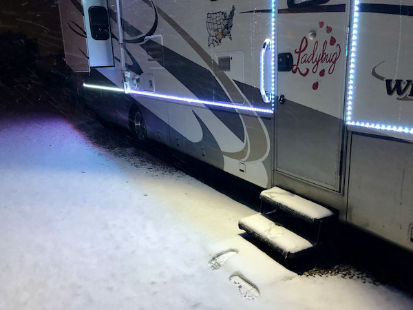 An RV with snow covered steps and patio en route Coast to Coast We Did It!