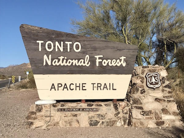 A brown and tan sign for Tonto National Forest Apache Trail en route Coast to Coast We Did It!