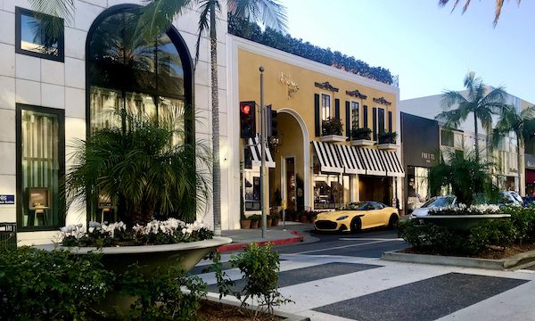 A yellow sports car parked in front of a yellow storefront in Opulent Beverly Hills California