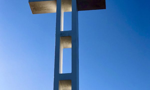 A large white cross against a clear blue sky in San Diego California