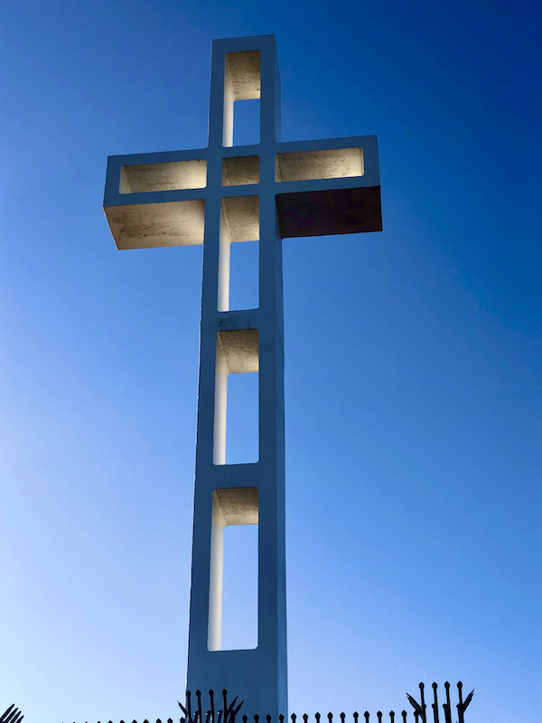 A large white cross against a clear blue sky in San Diego California