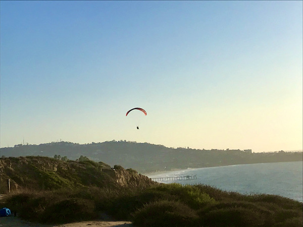 Mountains. beach and ocean with a hang glider in San Diego California