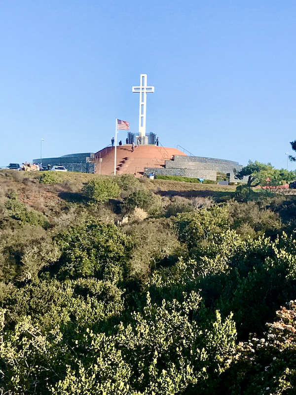 A huge white cross at the top of a mountain in San Diego California