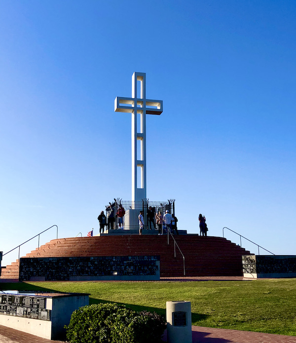 A large white cross at the top of a mountain in San Diego California