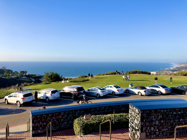 A view of the ocean, lawn and cars parked in San Diego California